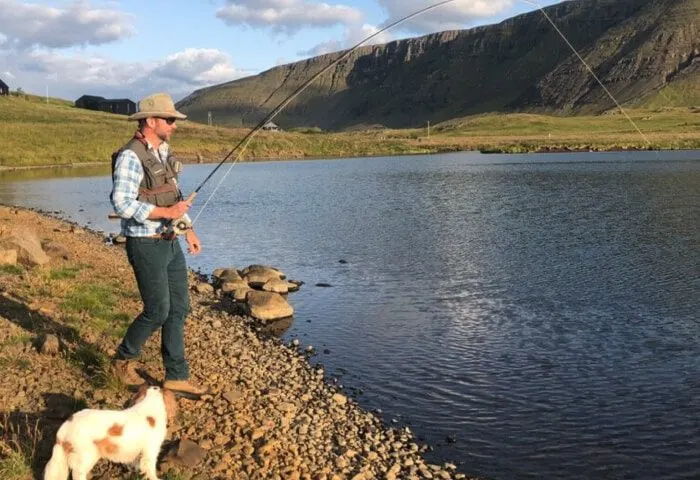 A man fishing by a lake