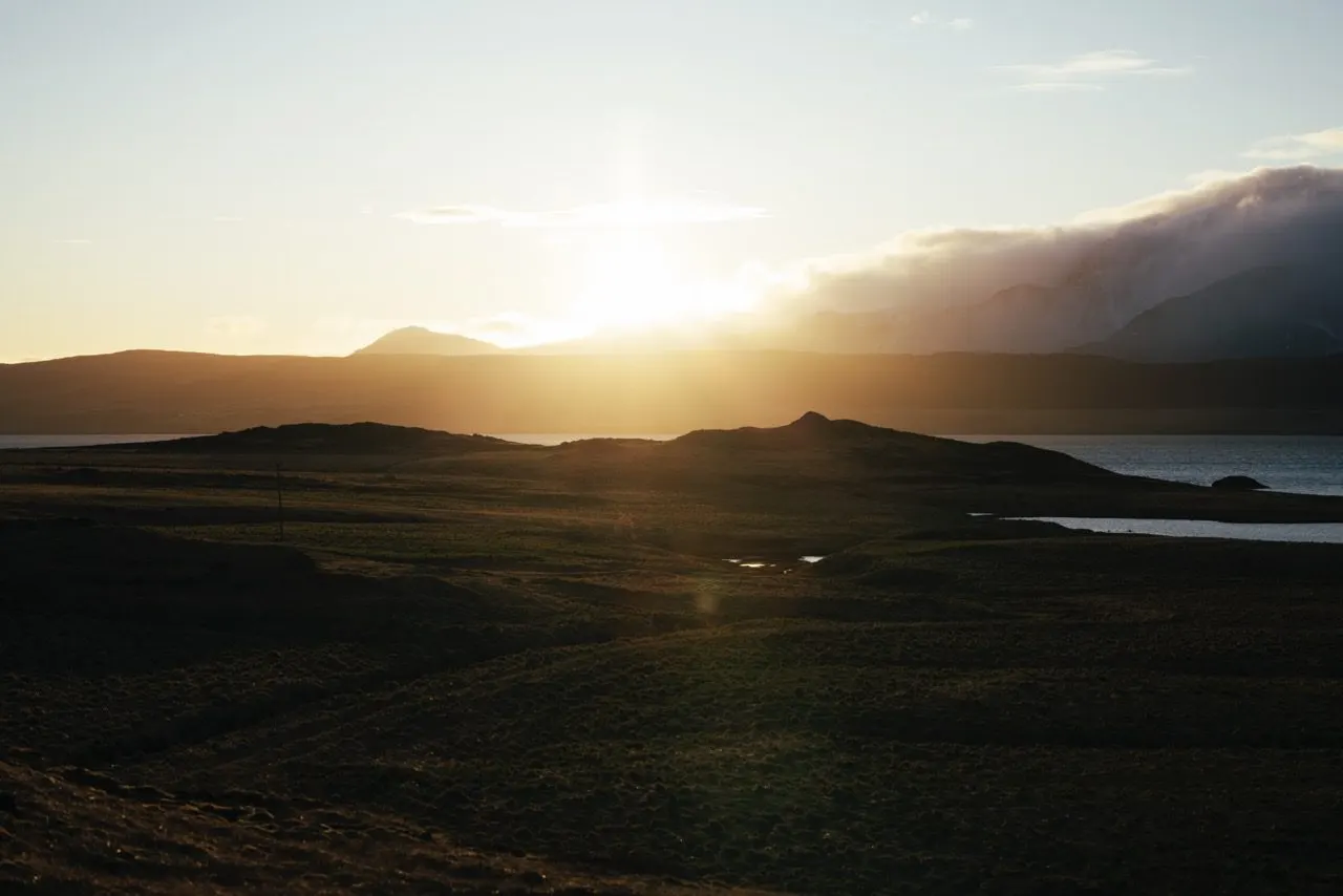 Sunset over the hills and the fjord at Hvammsvík