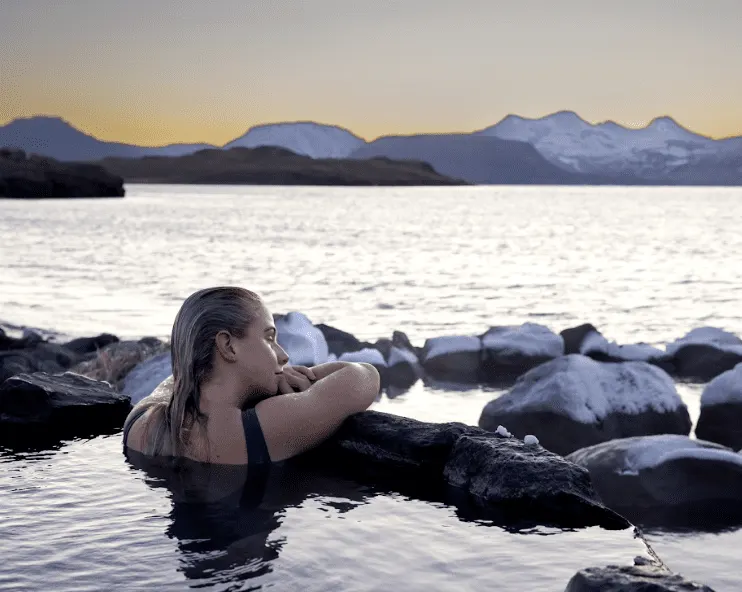 Women lounging in a lagoon with stunning views of the Whale Fjord.