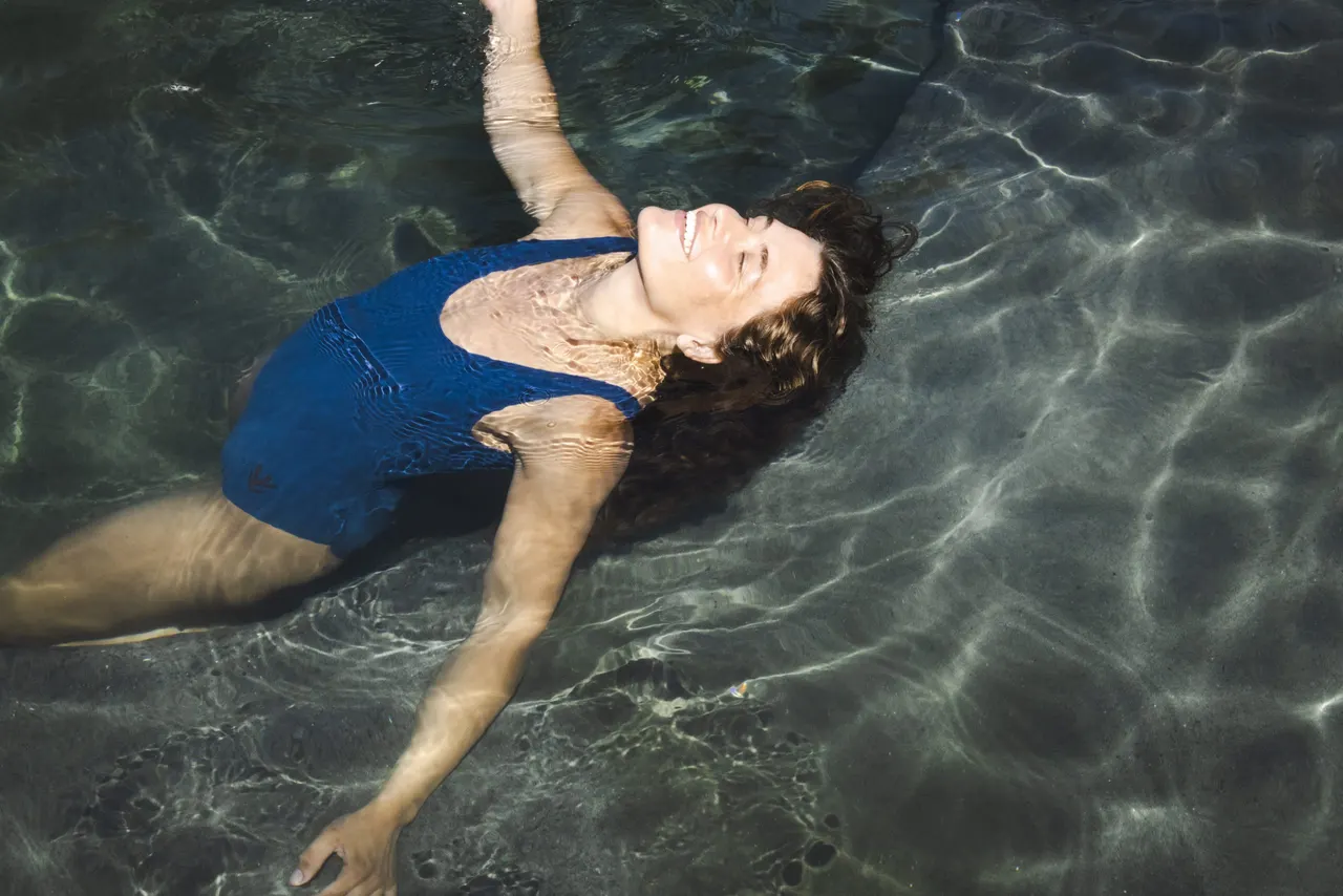Woman floating in a natural hot spring