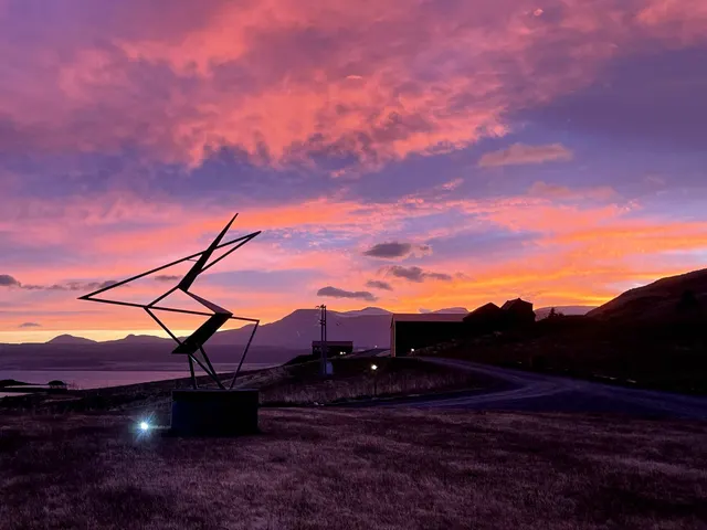 Sunset over a sculpture at Hvammsvík